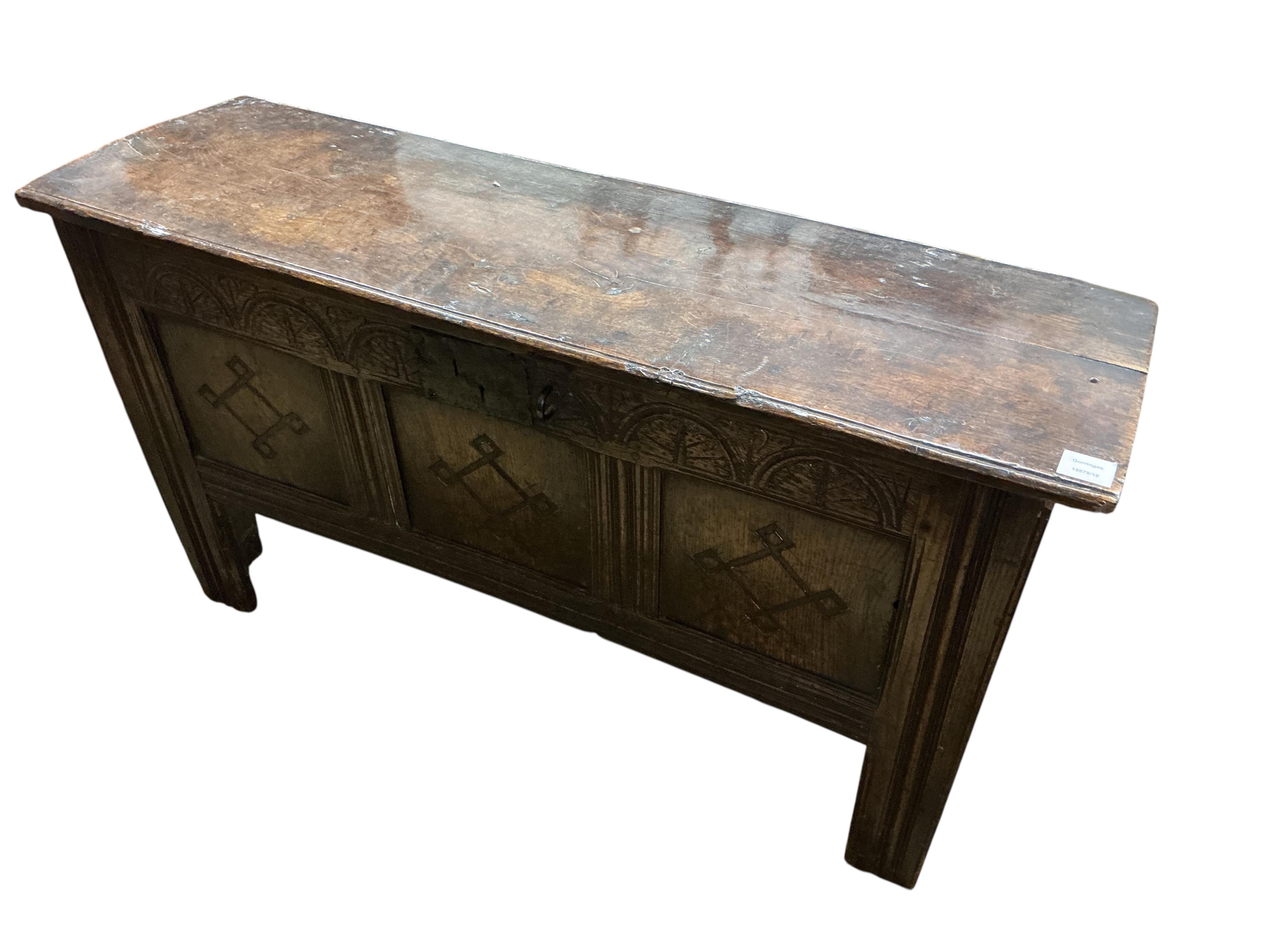 A 17th century oak triple panelled coffer, the front carved with lozenges, width 120cm, depth 39cm, height 66cm